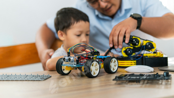 A boy are learning to build robot toys with their dad in the living room. Robot model