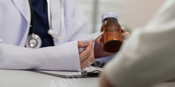 Doctor Consulting Patient and Discussing Medication in a Modern Medical Office Setting