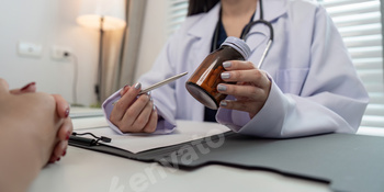 Doctor Consultation Patient and Prescribing Medication in a Modern Medical Office