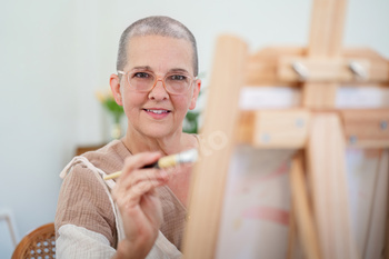 Senior woman painting on canvas at home, Elderly woman painting on a canvas, Happy retirement