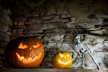 scary Halloween background with Jack'o'lanterns and skeleton