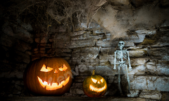 scary Halloween background with Jack'o'lanterns and skeleton