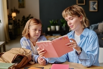 Mom and Daughter Looking at Notebook