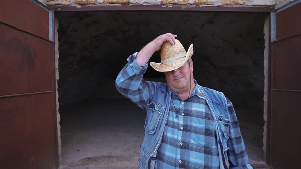 Desperate farmer near an empty barn.  World economic crisis