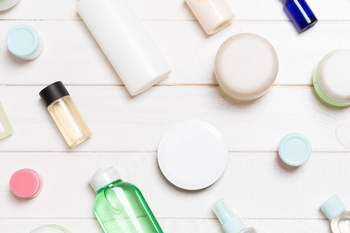 Top view of different cosmetic bottles and container for cosmetics