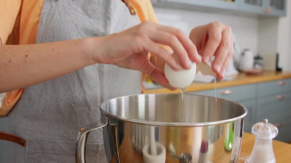 Woman Cooking Food and Breaking Eggs on Kitchen