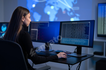 Busy Female IT Consultant in cyber security team working to prevent security threats, vulnerability