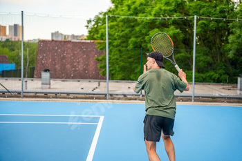 Professional male tennis player playing the tennis on outside court