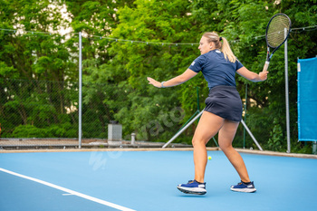 Professional female tennis player playing the tennis on outside court