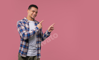 Happy promoter man presenting on workspace, mockup, promo commercial isolated on pink