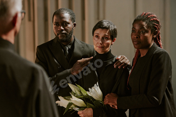 Family and Priest in Church