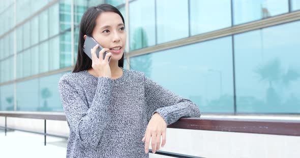 Woman talk to cellphone in street