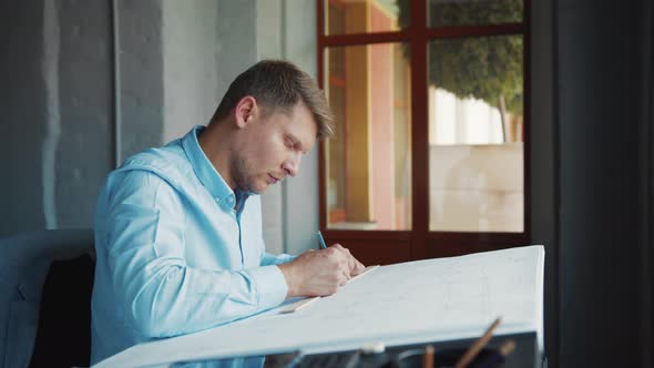 Young engineer at the window in the office