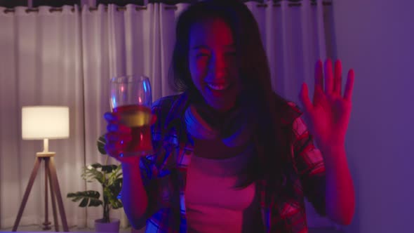 Young lady drink beer having fun happy disco neon night party event online via video call at home