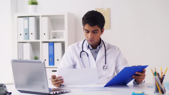 Doctor with Clipboard and Cardiogram at Hospital 44