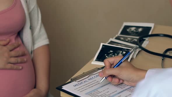 Pregnant Woman and Gynecologist Doctor at Hospital