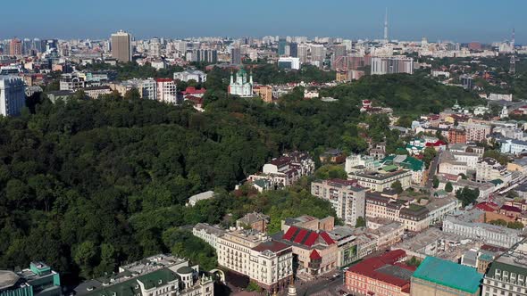 Beautiful flight over St. Andrew's Church in Kiev. Top view of Podol. Many buildings and churches.