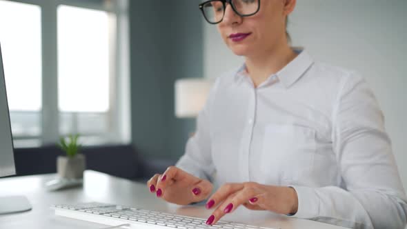 Woman Typing on a Computer Keyboard