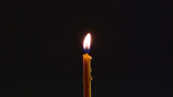 Candle Is on and Goes Out. Black Background. Close Up