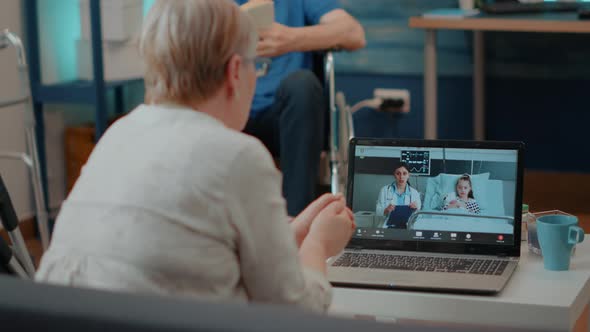 Elder Person Using Remote Conference Call on Laptop Computer