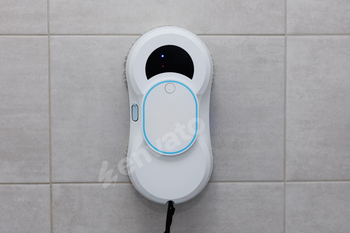 The robot washes the tiles in the shower.