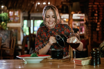 Woman is in the restaurant with food and drink