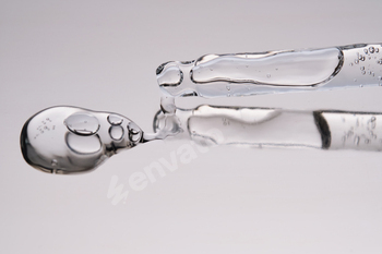 Pipette with cosmetic gel or serum close-up.