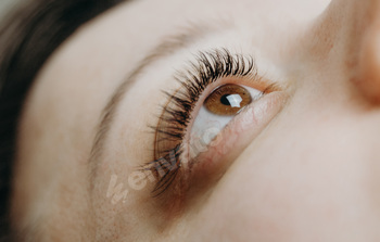 Open eye of a woman with eyelash extensions.