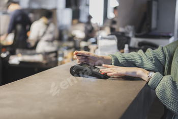 Customer Completing a Credit Card Transaction at a Retail Checkout