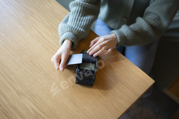 Customer Completing a Credit Card Transaction at a Retail Checkout