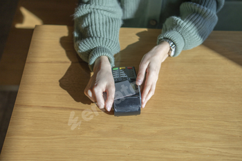 Customer Completing a Credit Card Transaction at a Retail Checkout