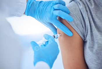 Closeup on hands of doctor giving a patient covid injection. Hands of doctor injecting patient with