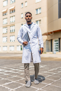 African doctor with lab coat outside the hospital