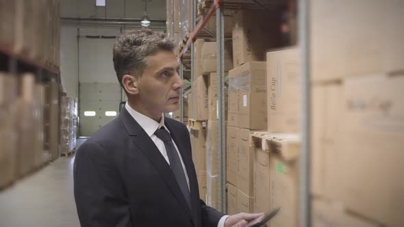 Businessman with digital tablet in warehouse