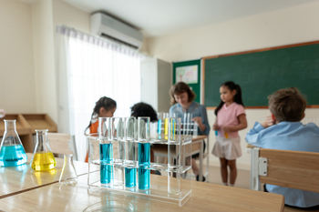 Adorable student learn with teacher in classroom at elementary school