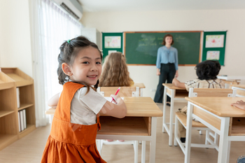 Portrait of Asian schoolgirl learning in classroom at elementary school.