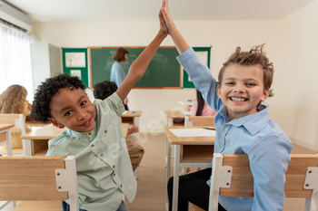 Portrait of student learn with teacher in classroom at elementary school.