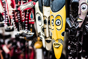 many colorful african masks at market