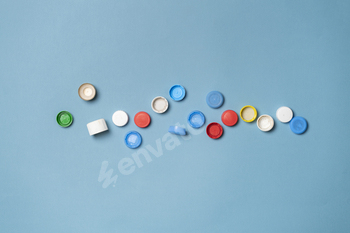 a pile of colorful plastic caps for bottles on color table