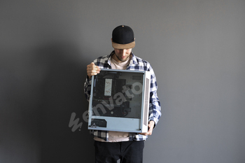 a young male person holding a new gamer pc desktop computer