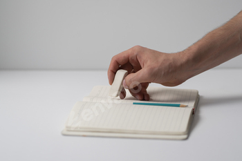 a student holding the rubber and erasing errors in notebook