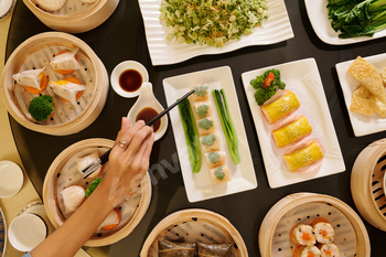 Woman Eating Rolls In The Restaurant