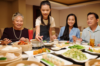 Family Eating Rolls In The Restaurant