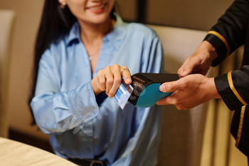 Woman Paying With Credit Card In The Restaurant