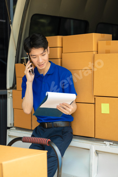 Asian delivery man, delivery men unloading cardboard boxes from truck.