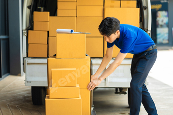 Asian delivery man, delivery men unloading cardboard boxes from truck.