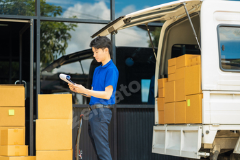 Asian delivery man, delivery men unloading cardboard boxes from truck.