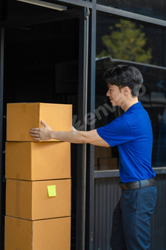 Asian delivery man, delivery men unloading cardboard boxes from truck.