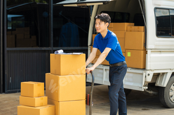 Asian delivery man, delivery men unloading cardboard boxes from truck.