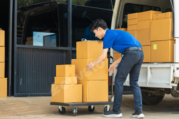 Asian delivery man, delivery men unloading cardboard boxes from truck.